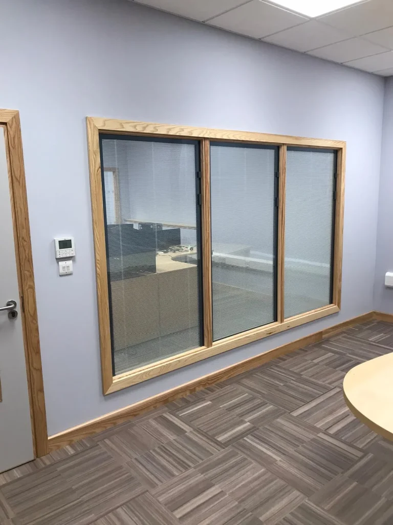 Commercial LVT office floors with a brown and grey wood-effect pattern laid in a basketweave design within a modern professional meeting room.